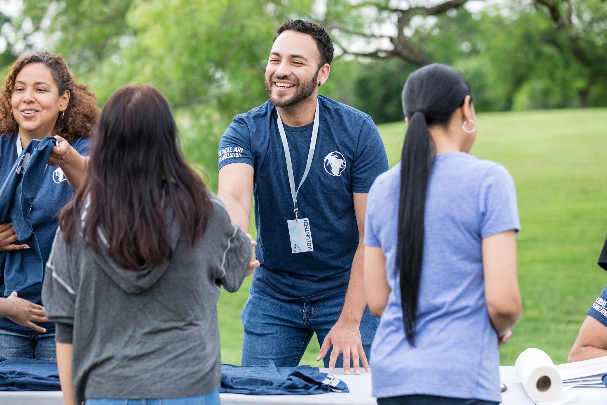 Volunteer greeting a community member at an outreach event