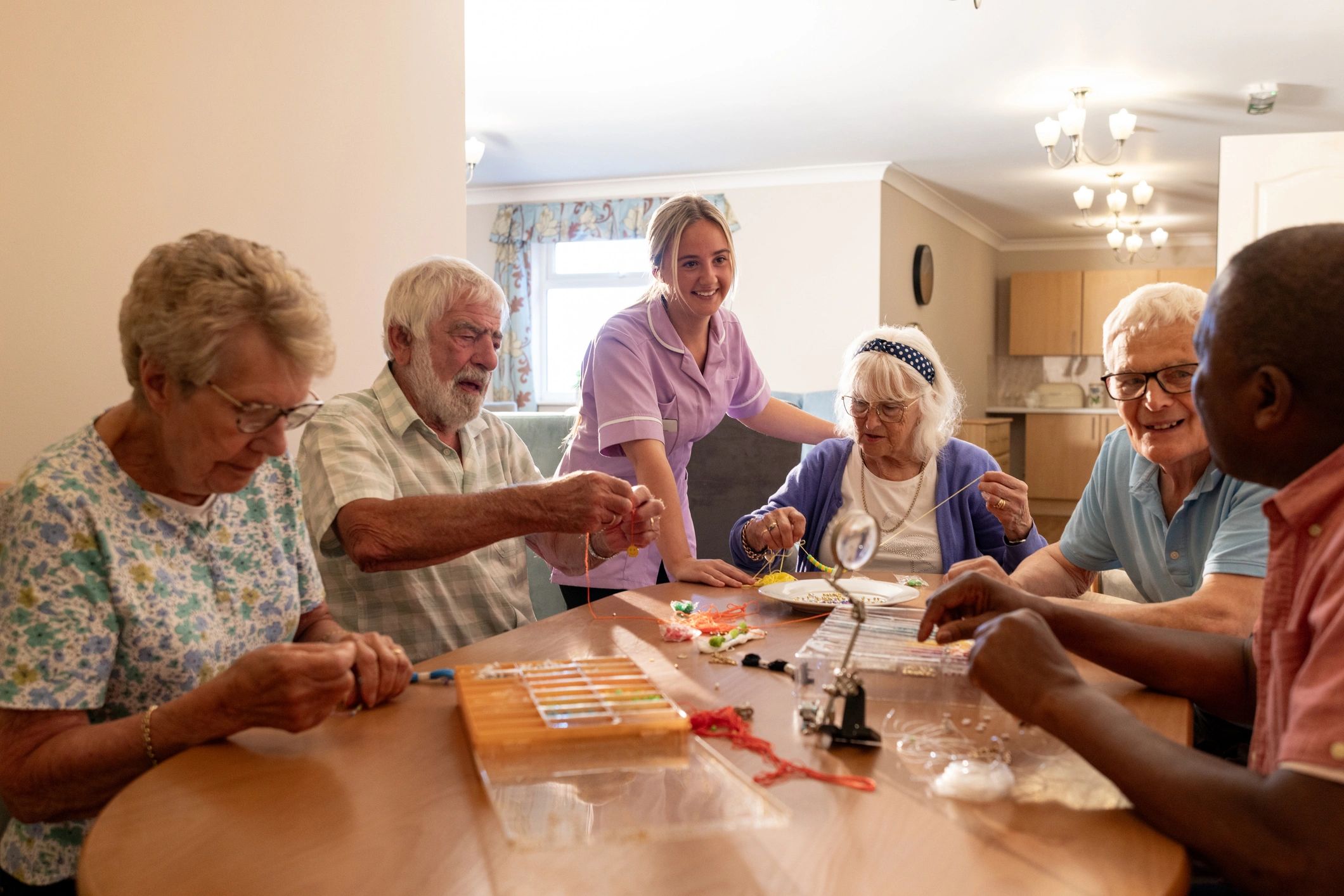 Support worker connecting with residents in a welcoming community setting